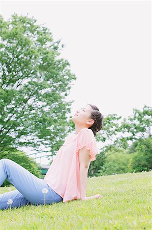 Japanese woman relaxing in a meadow Stock Photo - Rights-Managed, Code: 859-06710928