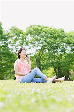 Japanese woman on the phone in a meadow Stock Photo - Rights-Managed, Code: 859-06710936