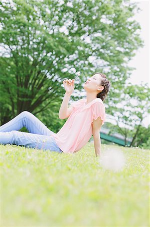 Japanese woman relaxing in a meadow Stock Photo - Rights-Managed, Code: 859-06710930