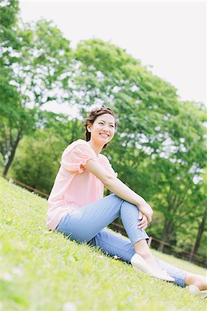 Japanese woman relaxing in a meadow Stock Photo - Rights-Managed, Code: 859-06710931