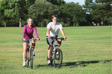 Couple riding mountain bikes in a park Stock Photo - Rights-Managed, Code: 859-06711043