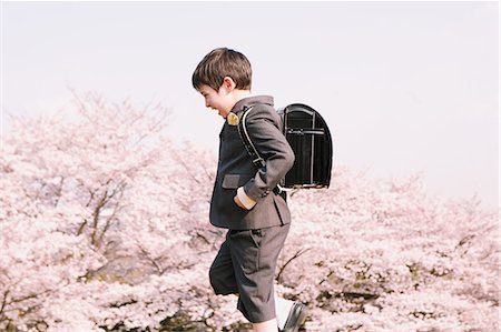 Young boy in school uniform walking Stock Photo - Rights-Managed, Code: 859-06808431