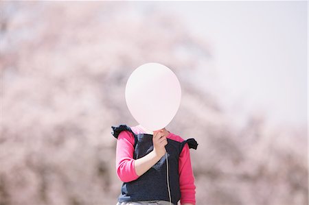 Young girl with balloon and cherry trees in the background Stock Photo - Rights-Managed, Code: 859-06808440