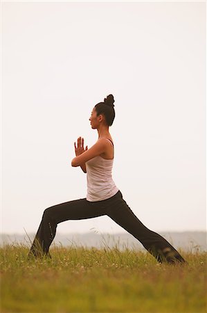 simsearch:622-06964353,k - Woman practicing Yoga on grassland Stock Photo - Rights-Managed, Code: 859-06808488