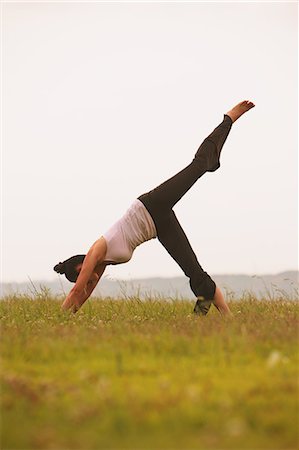 simsearch:622-06964353,k - Woman practicing Yoga on grassland Stock Photo - Rights-Managed, Code: 859-06808553