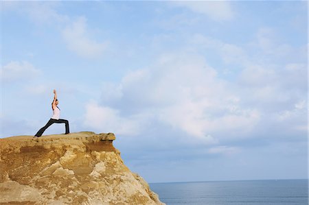 simsearch:622-06964353,k - Woman practicing Yoga on a cliff Stock Photo - Rights-Managed, Code: 859-06808560