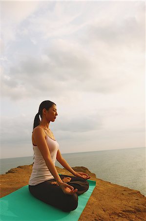 Woman practicing Yoga on a cliff Stock Photo - Rights-Managed, Code: 859-06808615