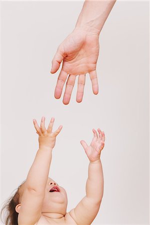 Baby reaching out for hand Photographie de stock - Rights-Managed, Code: 859-06808644