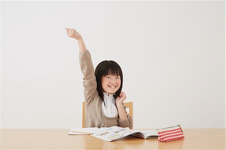 Young girl doing her homework on wooden desk Stock Photo - Rights-Managed, Code: 859-07710999