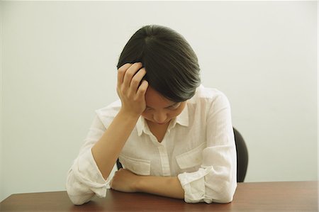 Desperate Japanese young businesswoman in a white shirt Stock Photo - Rights-Managed, Code: 859-07711086
