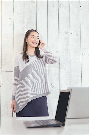 simsearch:622-08519691,k - Young Japanese woman working in a stylish office Stock Photo - Rights-Managed, Code: 859-08173123