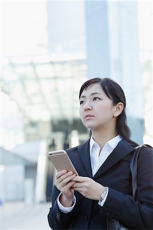 rookie - Japanese young businesswoman with phone downtown Tokyo Stock Photo - Rights-Managed, Code: 859-08887550