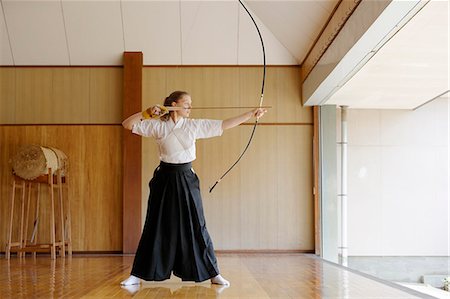 Caucasian woman practicing traditional Kyudo Japanese archery Stock Photo - Rights-Managed, Code: 859-09018717