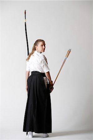Caucasian woman practicing traditional Kyudo Japanese archery on white background Stock Photo - Rights-Managed, Code: 859-09018728