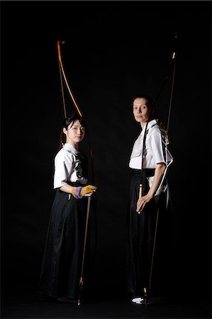 Multi-ethnic traditional Kyudo Japanese archery athletes on black background Stock Photo - Rights-Managed, Code: 859-09018735