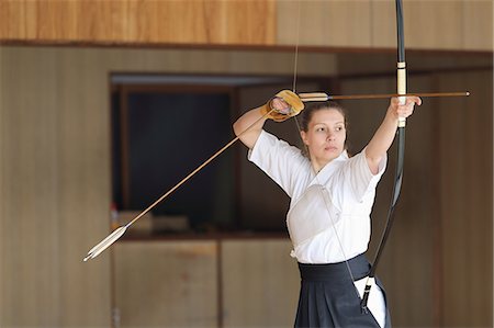 Caucasian woman practicing traditional Kyudo Japanese archery Stock Photo - Rights-Managed, Code: 859-09018748