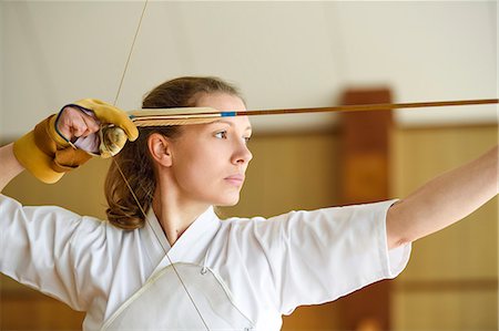 Caucasian woman practicing traditional Kyudo Japanese archery Stock Photo - Rights-Managed, Code: 859-09018855