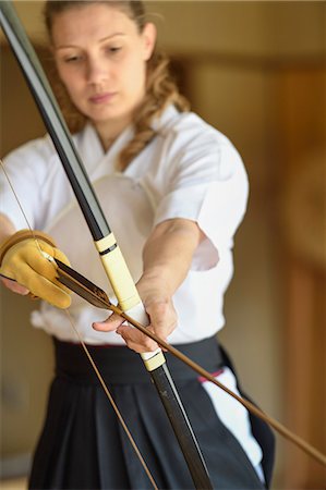 Caucasian woman practicing traditional Kyudo Japanese archery Stock Photo - Rights-Managed, Code: 859-09018858