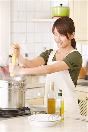 Side view of a woman holding uncooked noodles Stock Photo - Rights-Managed, Code: 859-03038448