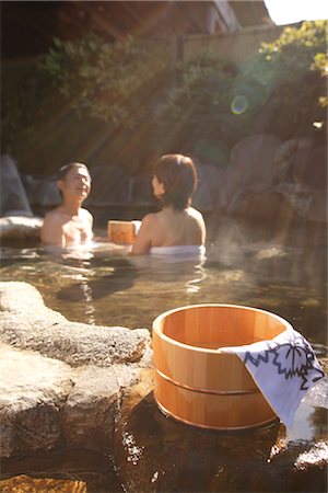 Couple relaxing in natural hot spring with wooden basket Stock Photo - Rights-Managed, Code: 859-03038564