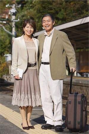 people waiting at train station - Couple posing for a camera shot Stock Photo - Rights-Managed, Code: 859-03038580