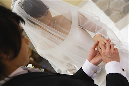 simsearch:859-03039180,k - Groom Putting the Ring on his Brides finger Stock Photo - Rights-Managed, Code: 859-03039171
