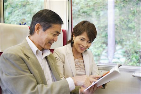 Couple reading book while traveling in train Stock Photo - Rights-Managed, Code: 859-03039261
