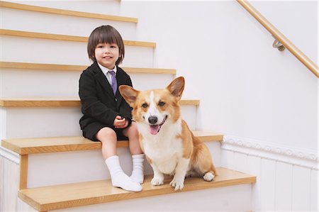 dog and boys playing image - Pembroke Welsh Corgi And Boy Stock Photo - Rights-Managed, Code: 859-03599473