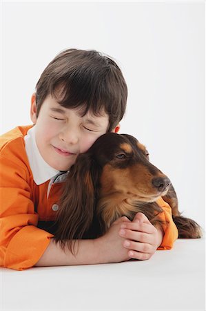 friend comfort hug - Miniature Dachshund And A Boy Stock Photo - Rights-Managed, Code: 859-03599536