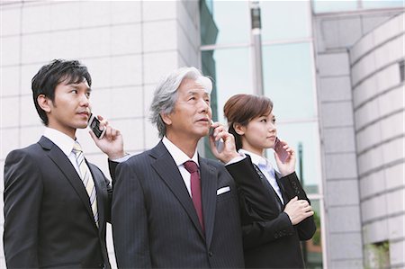 research building - Businessmen And Businesswoman Talking On The Phone Stock Photo - Rights-Managed, Code: 859-03600367