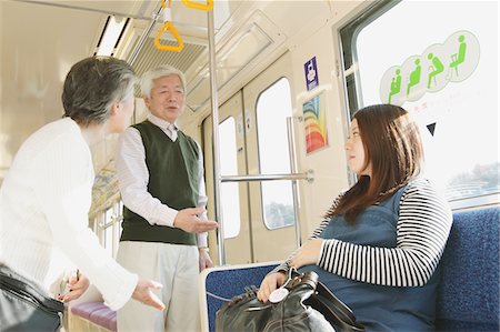 simsearch:859-03860700,k - Three people talking while traveling on a train Foto de stock - Con derechos protegidos, Código: 859-03755518