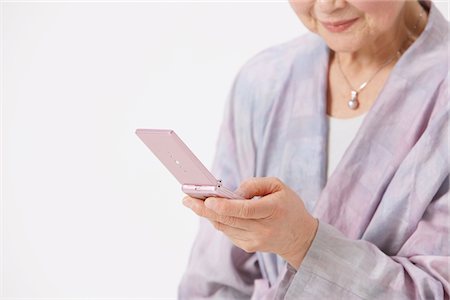 phone one person adult smile elderly - Senior Woman Texting On Cell Phone Stock Photo - Rights-Managed, Code: 859-03780018