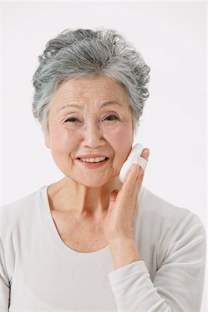 photos of 70 year old women faces - Senior Woman Making Up Her Face Stock Photo - Rights-Managed, Code: 859-03780010