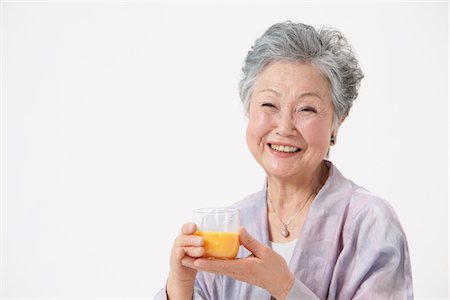 simsearch:859-03779954,k - Senior Woman Holding Glass Of Juice Stock Photo - Rights-Managed, Code: 859-03780023