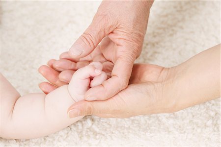 fingers holding - Hand Of A Baby On Woman's Hand Stock Photo - Rights-Managed, Code: 859-03780058