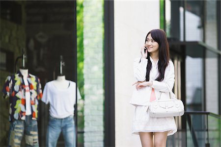 pretty women in mini skirts - Young Woman Talking on Mobile Phone Stock Photo - Rights-Managed, Code: 859-03782110