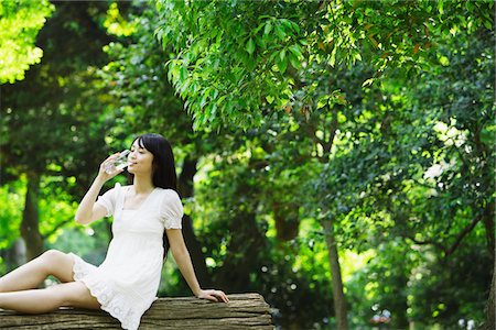 Young Woman in Forest Drinking water Stock Photo - Rights-Managed, Code: 859-03782202