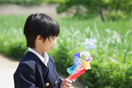 Boy  Playing with Paper Toy in Park Stock Photo - Rights-Managed, Code: 859-03782296