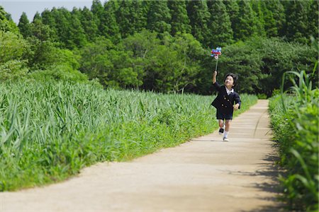 Boy Running in Park Holding Pinwheel Stock Photo - Rights-Managed, Code: 859-03782291