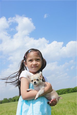 simsearch:859-06405000,k - Girl Standing Holding Puppy in Park Stock Photo - Rights-Managed, Code: 859-03782385