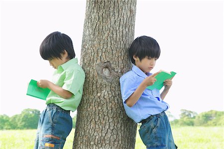 Twins Reading Books in Park Stock Photo - Rights-Managed, Code: 859-03782424