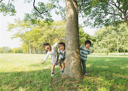 Children Hiding Behind Tree Trunk Stock Photo - Rights-Managed, Code: 859-03805799