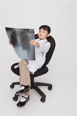 Girl Dressed Up As Doctor Checking X-Ray Stock Photo - Rights-Managed, Code: 859-03806117