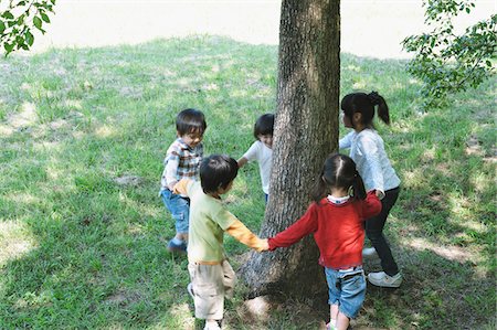 simsearch:614-07194495,k - Children Playing Near Tree Trunk Stock Photo - Rights-Managed, Code: 859-03806214