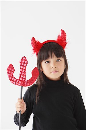 Girl Dressed In Halloween Costume as Devil Stock Photo - Rights-Managed, Code: 859-03806278