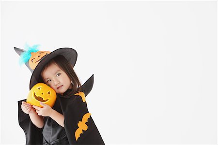 Girl Dressed Up As Witch Holding Pumpkin Stock Photo - Rights-Managed, Code: 859-03806294