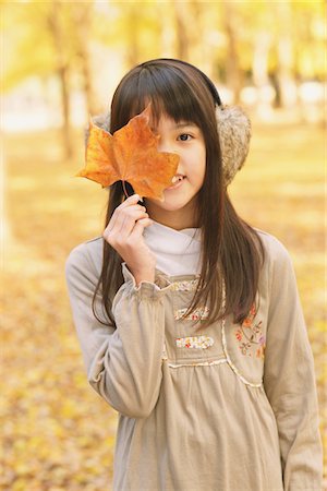 Pretty Girl Covering Her Face with Maple Leaf Stock Photo - Rights-Managed, Code: 859-03839327