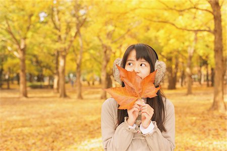 simsearch:859-03839388,k - Pretty Girl Covering Her Face with Maple Leaf Stock Photo - Rights-Managed, Code: 859-03839359