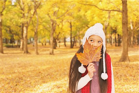 simsearch:859-03839388,k - Pretty Girl Covering Her Face with Maple Leaf Stock Photo - Rights-Managed, Code: 859-03839362