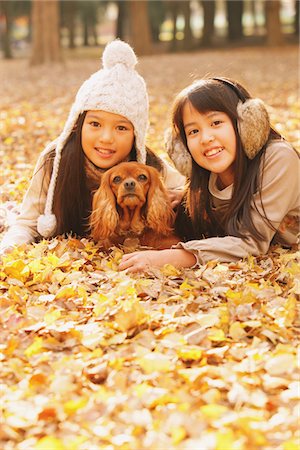 simsearch:859-03839388,k - Preteen Girls Lying Down In Leaves With Dog Stock Photo - Rights-Managed, Code: 859-03839405